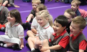 boys and girls laughing and smiling during theatre show