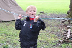 Child making his way across the tightrope obstacle