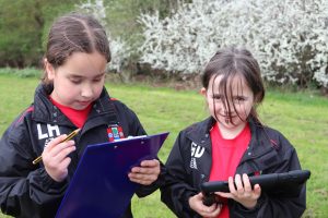 Two pupils searching for different plants