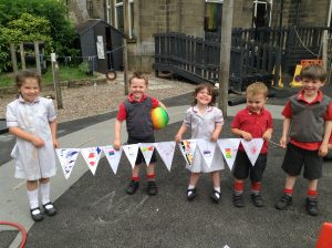 Nursery pose with their handmade World Cup Bunting