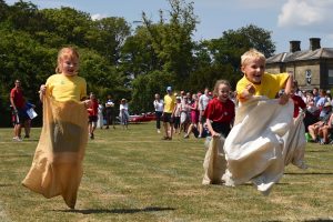 Young children enjoying a sack race on their school's sports day