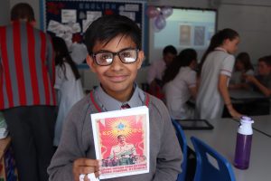 School pupil stands with his own storybook