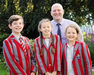 Photo shows Ghyll Royd School's Head Girl and Deputy Head Boy and Girl with Headteacher Mr David Martin