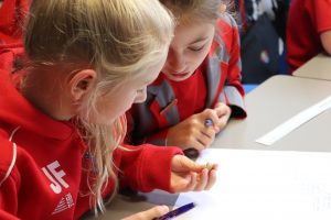 Ghyll Royd School girls look closely at a fossil