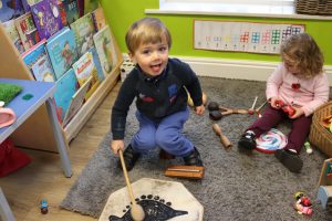 Ghyll Royd School playgroup visitor banging a drum