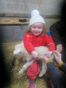 Ghyll Royd Pre-School pupil pictured with lamb