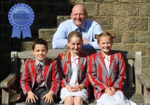 Independent School pupils from Ghyll Royd pose with headteacher David Martin in school courtyard