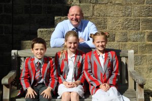 Headteacher David Martin sat on bench with Head pupils