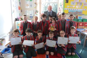 Ghyll Royd School Key Stage 1 children smiling with their certificates from being published poets