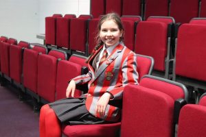 Ghyll Royd Head Pupil Georgie sat in the school's new theatre