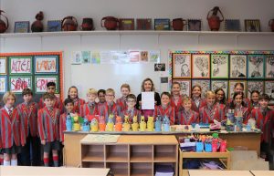 Ilkley Primary - Ghyll Royd pupils in art room with Art teacher Miss Smith holding their artsmark school silver award